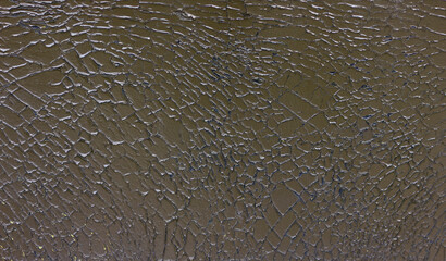 Close-up of dark cracked paint texture