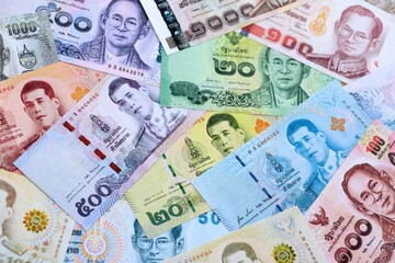Thai baht currency money bills. The current banknotes lies on table in big amount