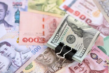 Thai baht currency money bills and bunch of us dollars. The concept of currency exchange