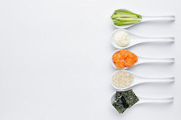 White spoons with sushi ingredients - salmon, cream cheese, isolated on a white background