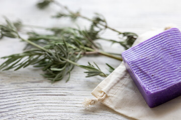 Cloth Bag, Lavender Soap, and Natural Lavender Leaves on a White Wooden Surface
