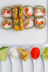 Sushi roll with eel, crab and caviar on a white background isolated