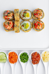 Baked sushi roll with salmon close-up on a white background isolated