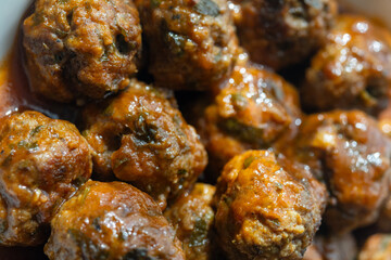Close-Up of Spanish Albóndigas in Tomato Sauce on a White Plate
