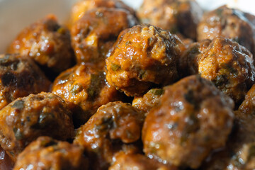 Close-Up of Spanish Albóndigas in Tomato Sauce on a White Plate
