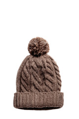 Brown cable knit woolen hat with a matching faux fur pompom.