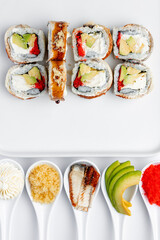 Sushi roll with eel, crab and caviar on a white background isolated
