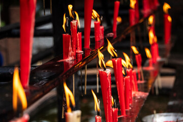 lit votive candles, Wannian temple ('Temple of the ten thousand years'), Emeishan, Leshan Prefecture, Sichuan, People's Republic of China, Asia