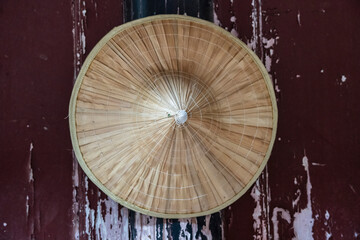 straw hat hanging on a peeling wooden wall, Wannian temple ('Temple of the ten thousand years'), Emeishan, Leshan Prefecture, Sichuan, People's Republic of China, Asia