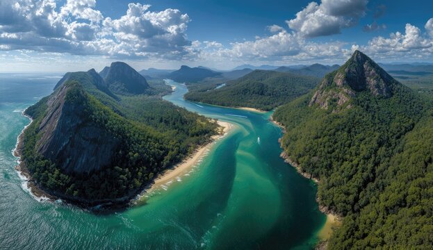 Panoramic coastal vista, showcasing a secluded bay, rugged mountains, and lush greenery.  A curving inlet stretches into the interior, with a sandy beach visible within