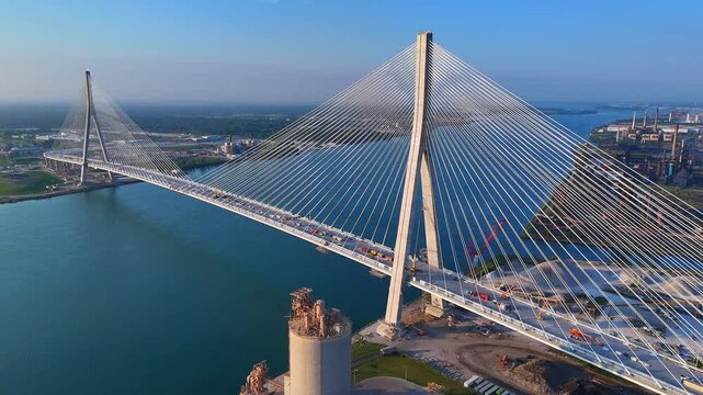 Aerial drone view of Gordie Howe Bridge crossing wide Detroit River below