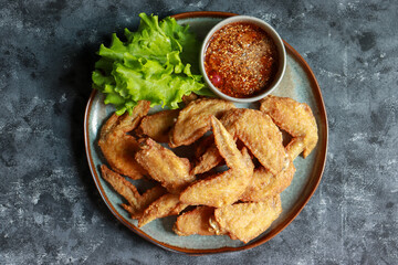Crispy Fried Chicken wings with Fish Sauce serve with spicy dipping sauce