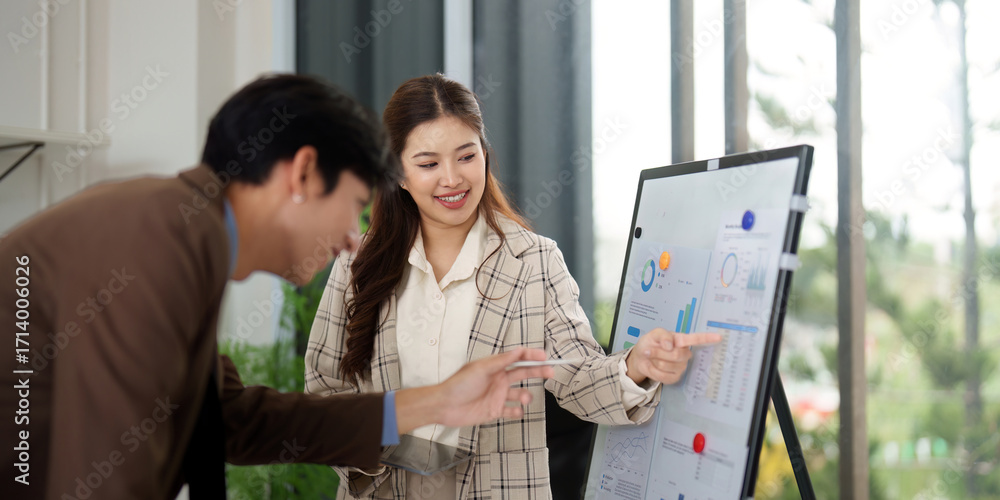 Poster data presentation. business professionals discussing analytics on a presentation board.