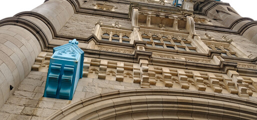 Low-angle of the Tower Bridge in London, UK. Focusing on architectural details of stone and metal structure. Classic landmark, beautiful design and historic character.