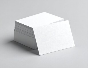 Blank business cards stacked on a light gray surface
