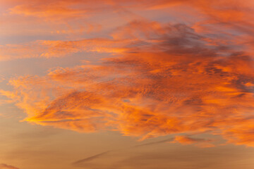 Serene sunset sky with twilight colors and dramatic clouds forming a vibrant natural background perfect for creative design use
