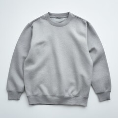 A light gray, plain, crew-neck sweatshirt laid flat on a white surface
