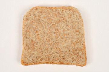 A top-down shot of a single slice of whole-grain bread on a clean white background with plenty of copy space