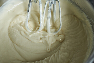 Mixing the dough with a mixer in a bowl, close-up