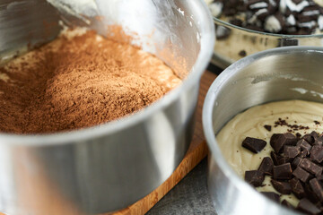 preparation of chocolate cake with cocoa powder and chocolate chips, selective focus