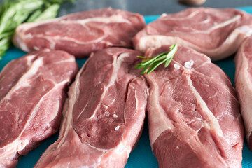 Close-up of raw beef steaks with spices on a cutting board. Raw meat.