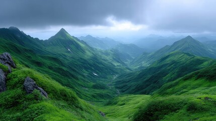 Obraz premium Lush Green Mountain Range Peaks Under Dramatic Cloudy Sky in Daylight Scenic Landscape View of Forested Valleys and Rocky Outcrops Wide Angle Shot