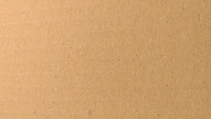 Background of brown kraft paper or cardboard texture. Abstract pattern of beige rough carton, old paper sheet, parchment or papyrus surface.