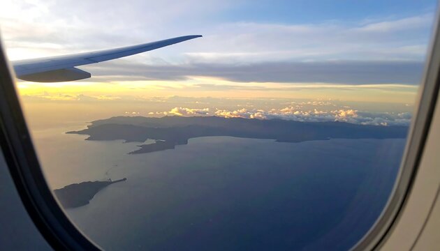Aerial view of islands from an airplane window at sunset