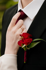 bride straightens the groom's tie