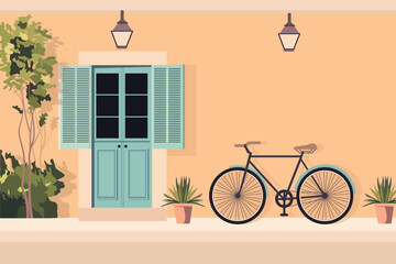 A vintage bicycle is leaning against a wall of a house with a beautiful door giving it an antique architectural feel