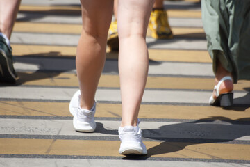 people crossing the road at a pedestrian crossing