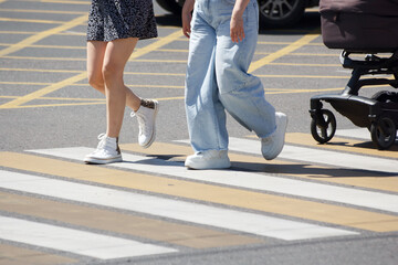 people crossing the road at a pedestrian crossing