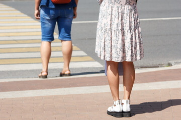 pedestrians are waiting for a signal to cross the road