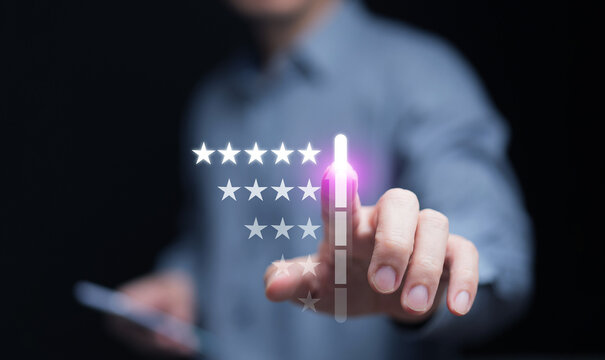Businessman hand pressing five-star rating on virtual screen, concept of customer satisfaction, feedback, quality service, and user experience improvement for digital business success.