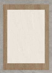 Blank white paper framed in light wood against a gray textured background