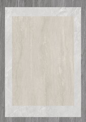 Rectangular beige marble tile with white border on wooden surface