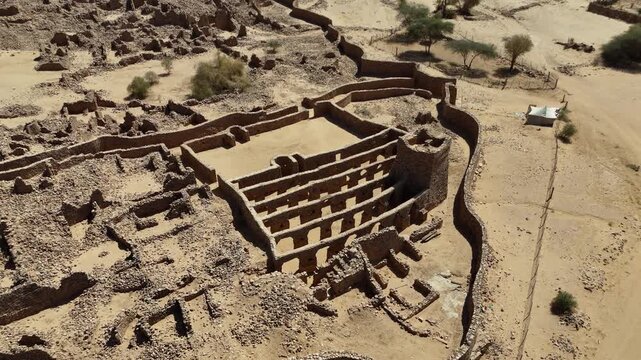 Drone flight over Ouadane, the historic desert town of Mauritania with preserved fortress, ancient ruins and UNESCO heritage charm