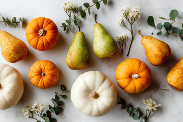 A composition of orange and white pumpkins, green pears, and small white flowers with green leaves arranged artistically.