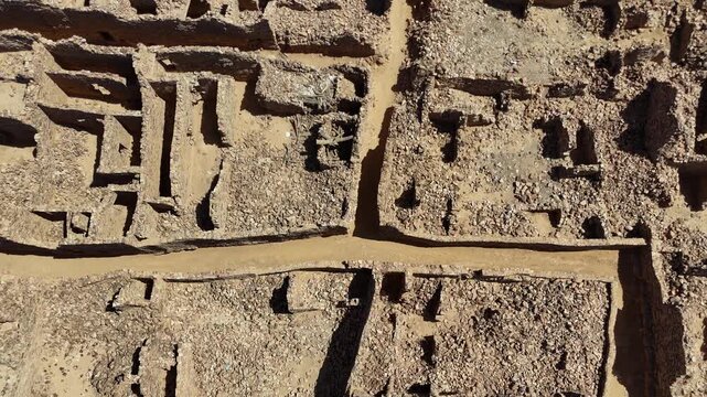 Aerial drone top down view of stone ancient ruins of Ouadane, Mauritania, UNESCO World Heritage site in the Sahara desert