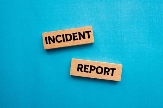 Incident report message written on wooden blocks on blue background. Conceptual incident report symbol. Copy space.