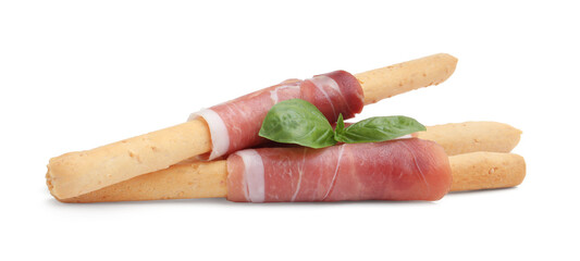 Delicious grissini sticks with prosciutto and basil isolated on white