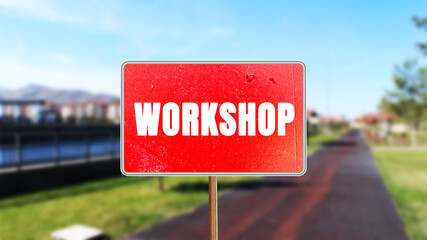 Workshop message written on red road sign. Conceptual Workshop symbol. Copy space.