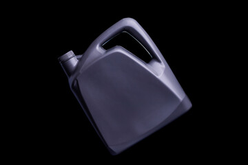 Black oil gallon or lubricant barrel or motor oil bottle isolated on black and dark background.