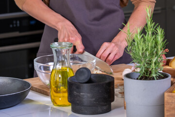 Woman chef skillfully chopping fresh vegetables in a modern kitchen, surrounded by herbs and cooking ingredients, showcasing culinary preparation and vibrant cooking atmosphere with copy space
