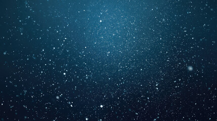 Fototapeta premium Abstract particles shimmering against a gradient dark blue background.