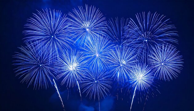 Vibrant blue fireworks burst against a dark night sky