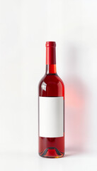 Obraz premium Red wine bottle with blank label on white background 
