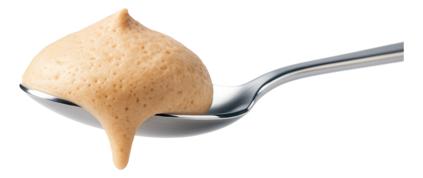A spoonful of smooth, light brown mousse with a creamy texture, showing a velvety and airy consistency.
