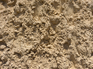 Heap of yellow construction sand in sunny day, fragment