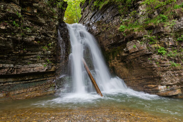 Fototapeta premium Bukhtivets waterfall falling from precipitous cliff ledge in Ukrainian Carpathians